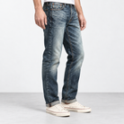 Stonewashed tapered cotton blend jeans in stonewashed blue, side view on a model