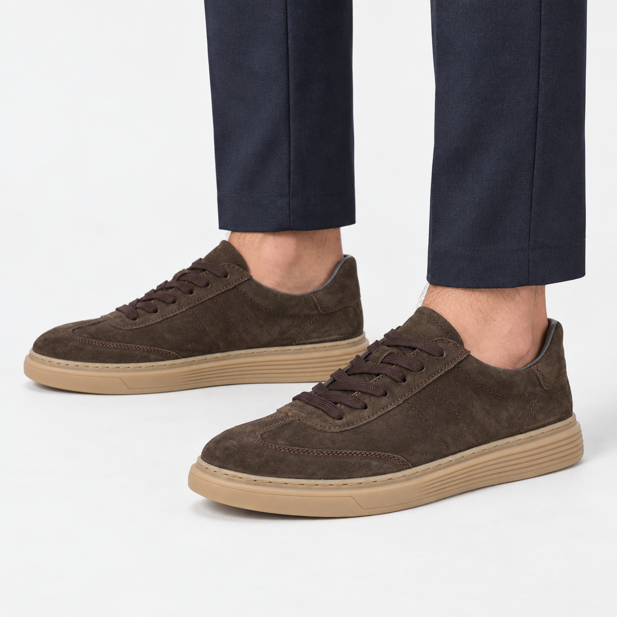 Suede cupsole sneakers with tonal laces in dark brown, side view on a model
