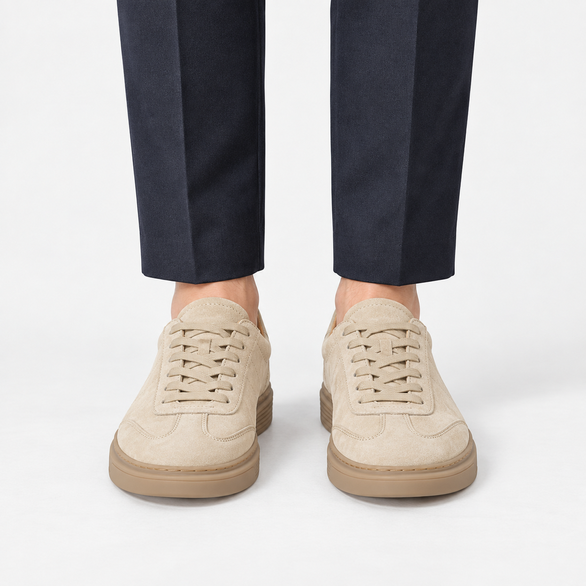 Suede cupsole sneakers with tonal laces in sand, front view on a model