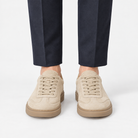 Suede cupsole sneakers with tonal laces in sand, front view on a model