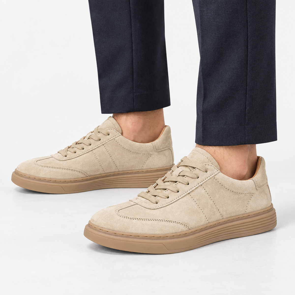 Suede cupsole sneakers with tonal laces in sand, side view on a model