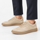Suede cupsole sneakers with tonal laces in sand, side view on a model