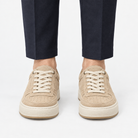 Suede panel low top sneakers in beige, front view on a model