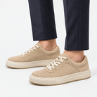 Suede panel low top sneakers in beige, side view on a model