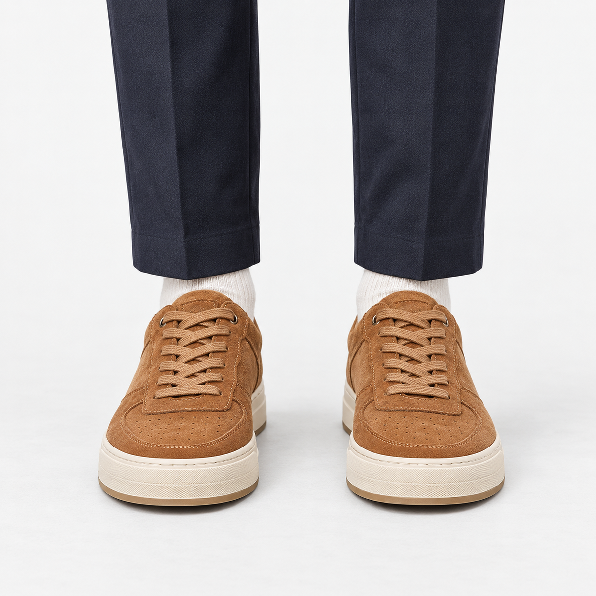 Suede panel low top sneakers in tan, front view on a model