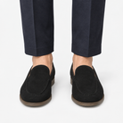 Suede slip on loafers with apron stitching in black, front view on a model