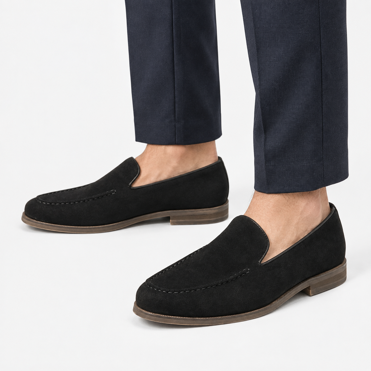 Suede slip on loafers with apron stitching in black, side view on a model