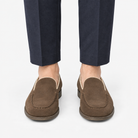 Suede slip on loafers with apron stitching in brown, front view on a model