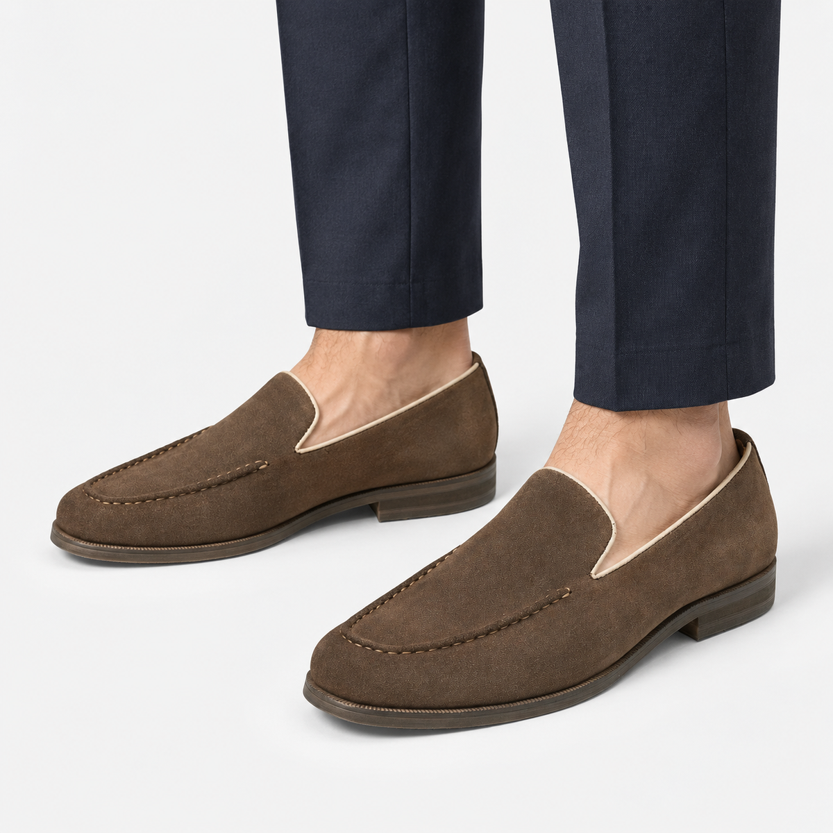 Suede slip on loafers with apron stitching in brown, side view on a model