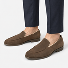 Suede slip on loafers with apron stitching in brown, side view on a model
