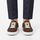 Suede sneakers with contrast heel tabs in brown, front view on a model