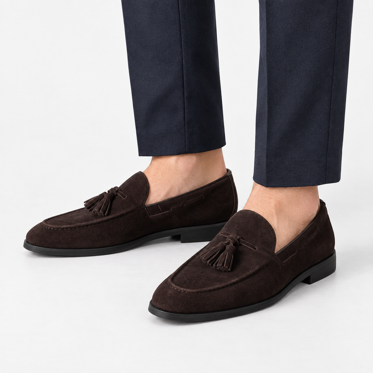 Suede tassel loafers with rubber soles in dark brown, side view on a model