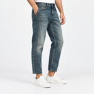 Vintage wash slim straight jeans in blue cropped, side view on a model