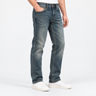 Vintage wash slim straight jeans in blue full length, side view on a model