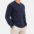 Waffle knit long sleeve henley in navy, side view on a model