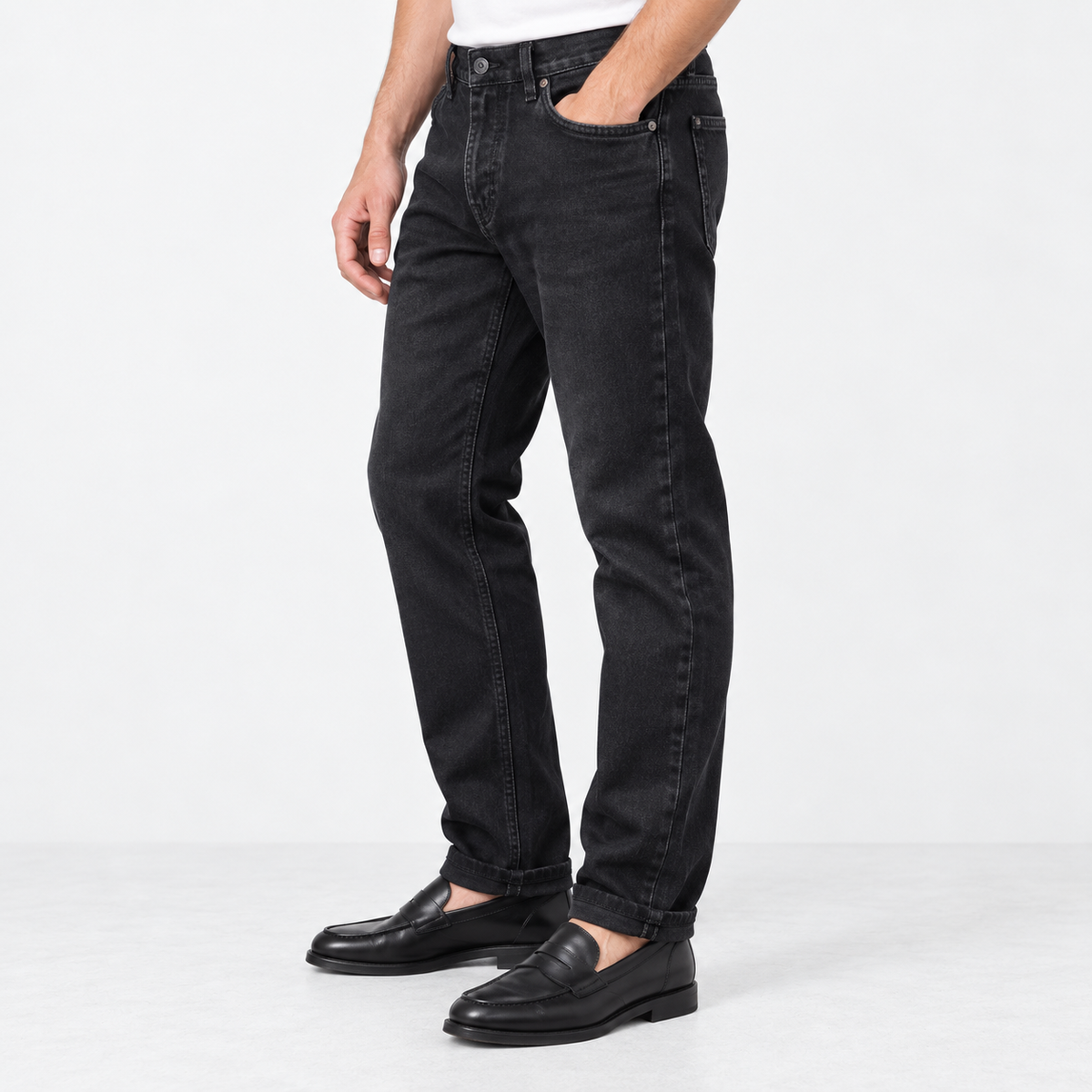 Washed black straight leg stretch jeans in washed black, side view on a model