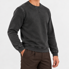 Washed cotton crew neck sweatshirt in washed black, side view on a model
