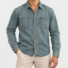 Washed denim twin pocket shirt in washed gray blue, front view on a model