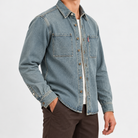 Washed denim twin pocket shirt in washed gray blue, side view on a model